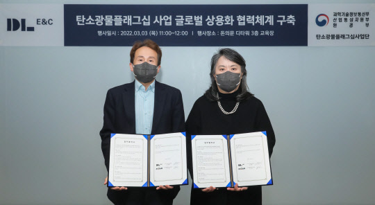 유재형 DL이앤씨 CCUS 담당임원(왼쪽)과 안지환 한국지질자원연구원 탄소광물플래그십 사업단장이 '탄소광물화 원천기술 글로벌 상용화 협력체계 구축'을 위한 업무협약을 체결한 뒤 기념촬영을 하고 있다. <DL이앤씨 제공>